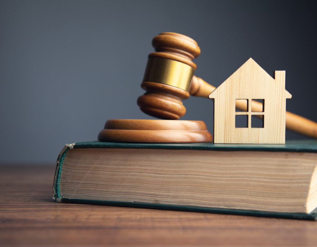 Judge auction and real estate concept. House model, gavel and law books