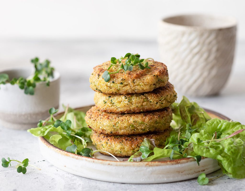 Green broccoli and quinoa burgers served with lettuce and microgreens. Tasty vegan food. close-up