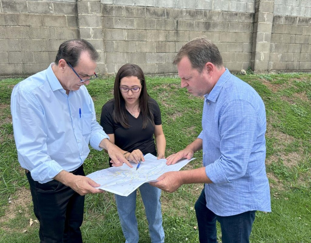 Helinho Zanatta, a engenheira Juliana Soares Leme Correia e Luciano Celêncio observam mapa com pontos que apresentam problemas no pavimento