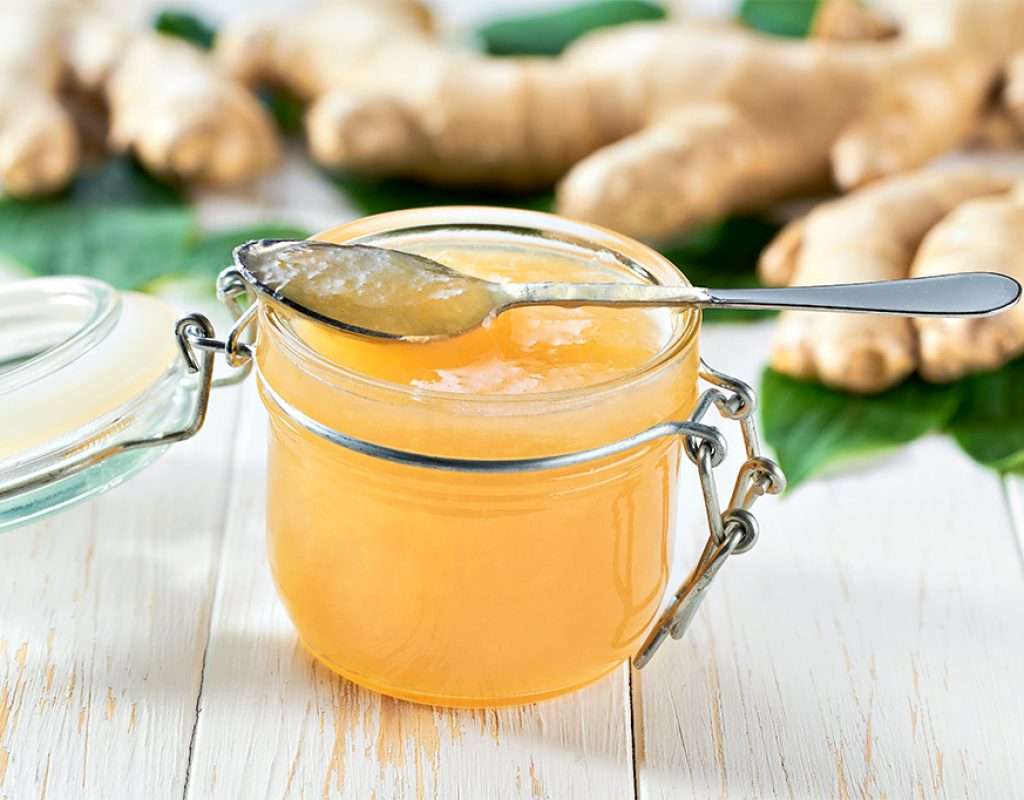 Delicious ginger jam on a wooden table close-up.