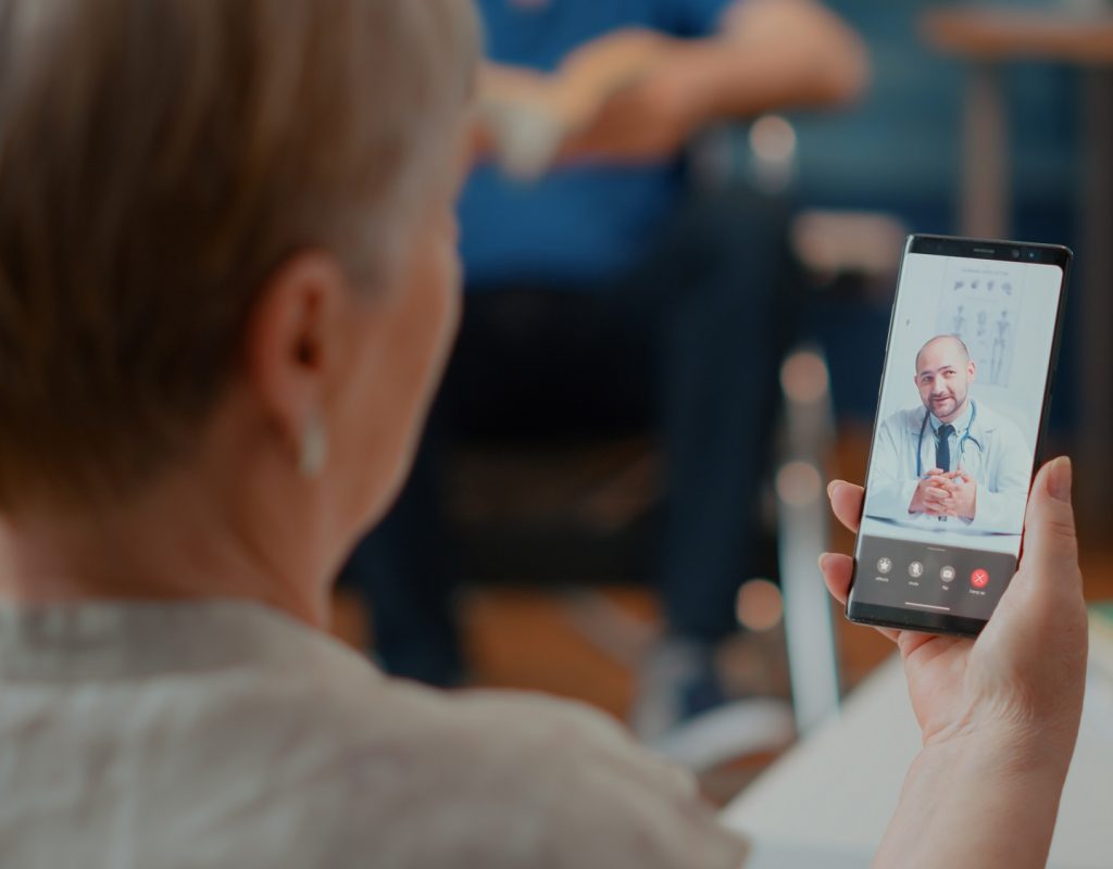 Retired woman attending online consultation on videocall with medic, talking about health care. Senior adult using online videoconference with doctor for telemedicine and telehealth.