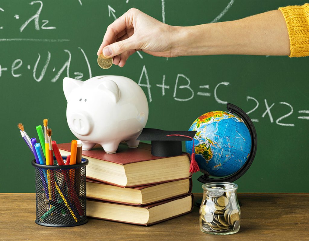 person-putting-coins-piggy-bank-with-books-pencils